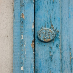 blue wooden door number 105